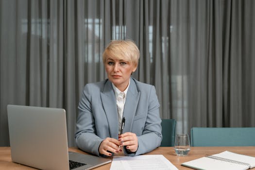 person holding a pen and reviewing documents