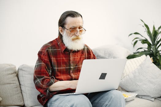 elderly man using a laptop to check mortgage rates