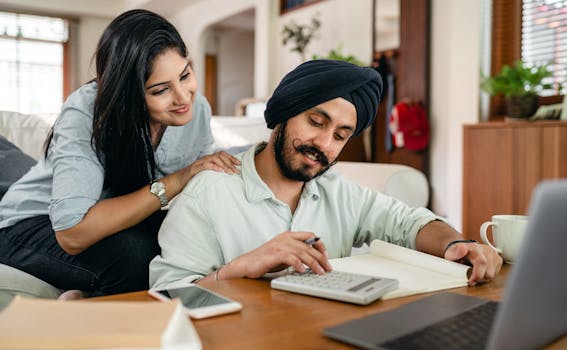 retired couple reviewing finances on a laptop