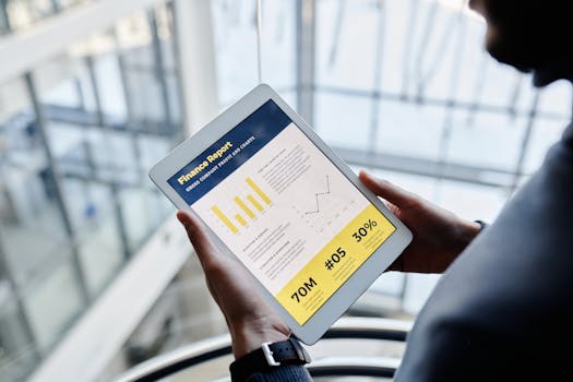 man reading financial news on a tablet