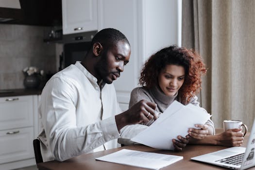 retired couple reviewing finances on a laptop