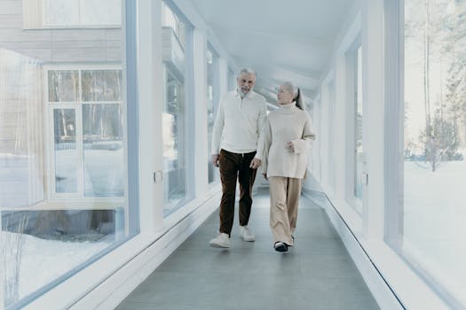 retired couple smiling while looking at financial documents